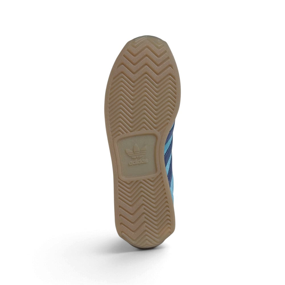 Outsole View: Bottom-down view of the gum rubber outsole, displaying the traditional herringbone traction pattern and centralized adidas branding block.   