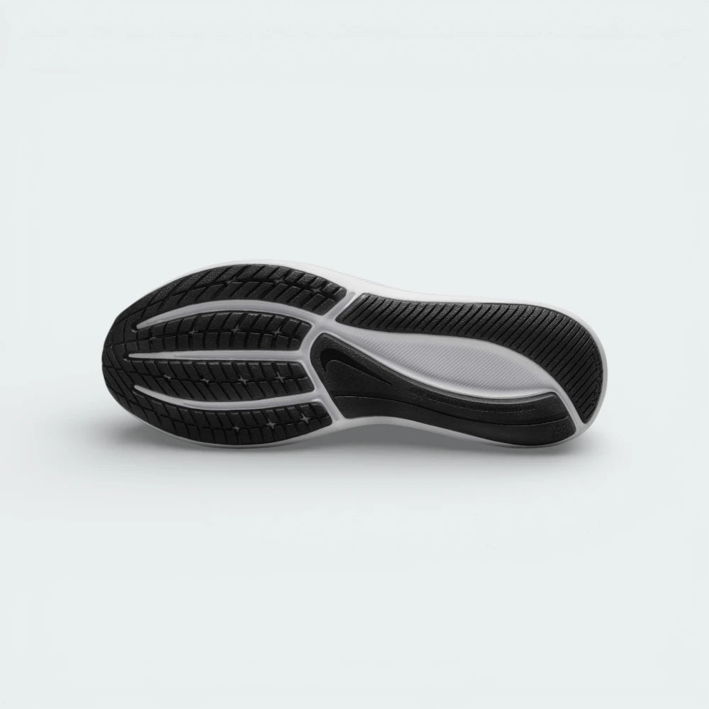 View of the black rubber outsole, showcasing the signature molded star traction pattern and flexible grooves.