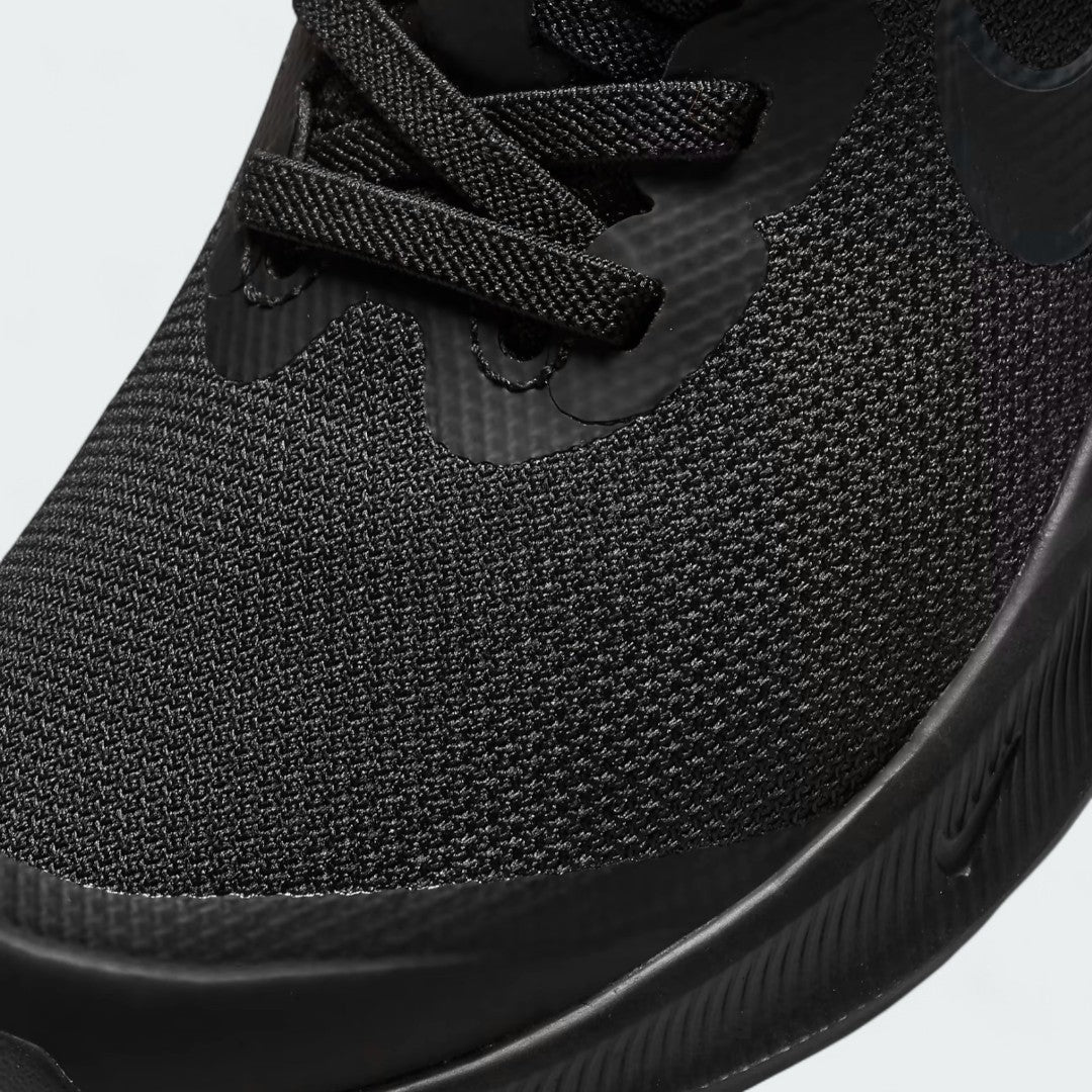 Close-up zoom on the front of the Nike Star Runner 3 Children's black shoes, showing the breathable mesh toe box, elastic laces, and hook-and-loop strap closure.