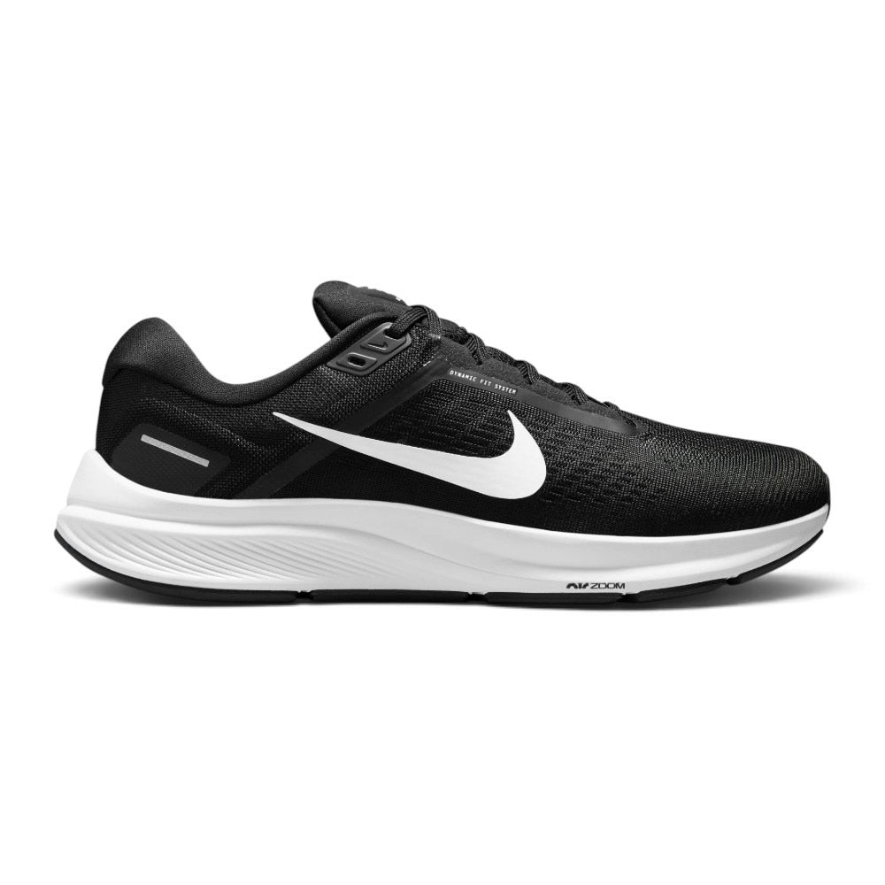Highlights the structured lateral silhouette showing the Black engineered mesh upper, prominent White Nike Swoosh extending across the midfoot, "Dynamic Fit System" overlay print, sculpted white foam midsole debossed with "Air Zoom" lettering, and durable black rubber outsole. Main image