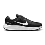 Highlights the structured lateral silhouette showing the Black engineered mesh upper, prominent White Nike Swoosh extending across the midfoot, "Dynamic Fit System" overlay print, sculpted white foam midsole debossed with "Air Zoom" lettering, and durable black rubber outsole.