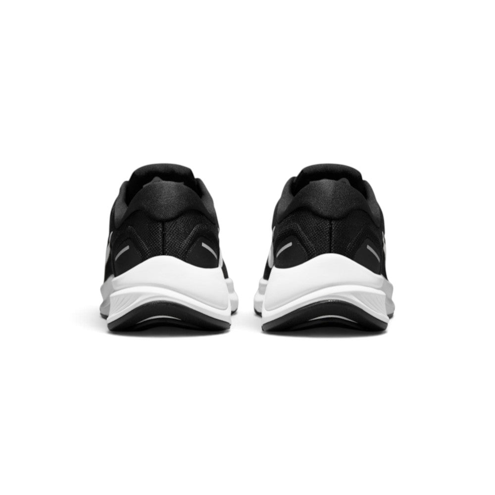 Focuses on the rear profile, displaying the moulded black heel counter, dual horizontal reflective safety strips, and the wide flared base of the white crash-pad foam midsole.