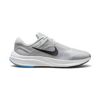 Highlights the structured lateral silhouette showing the Pure Platinum engineered mesh upper, bold black Nike Swoosh extending across the midfoot, sculpted white foam midsole, and durable black rubber outsole.