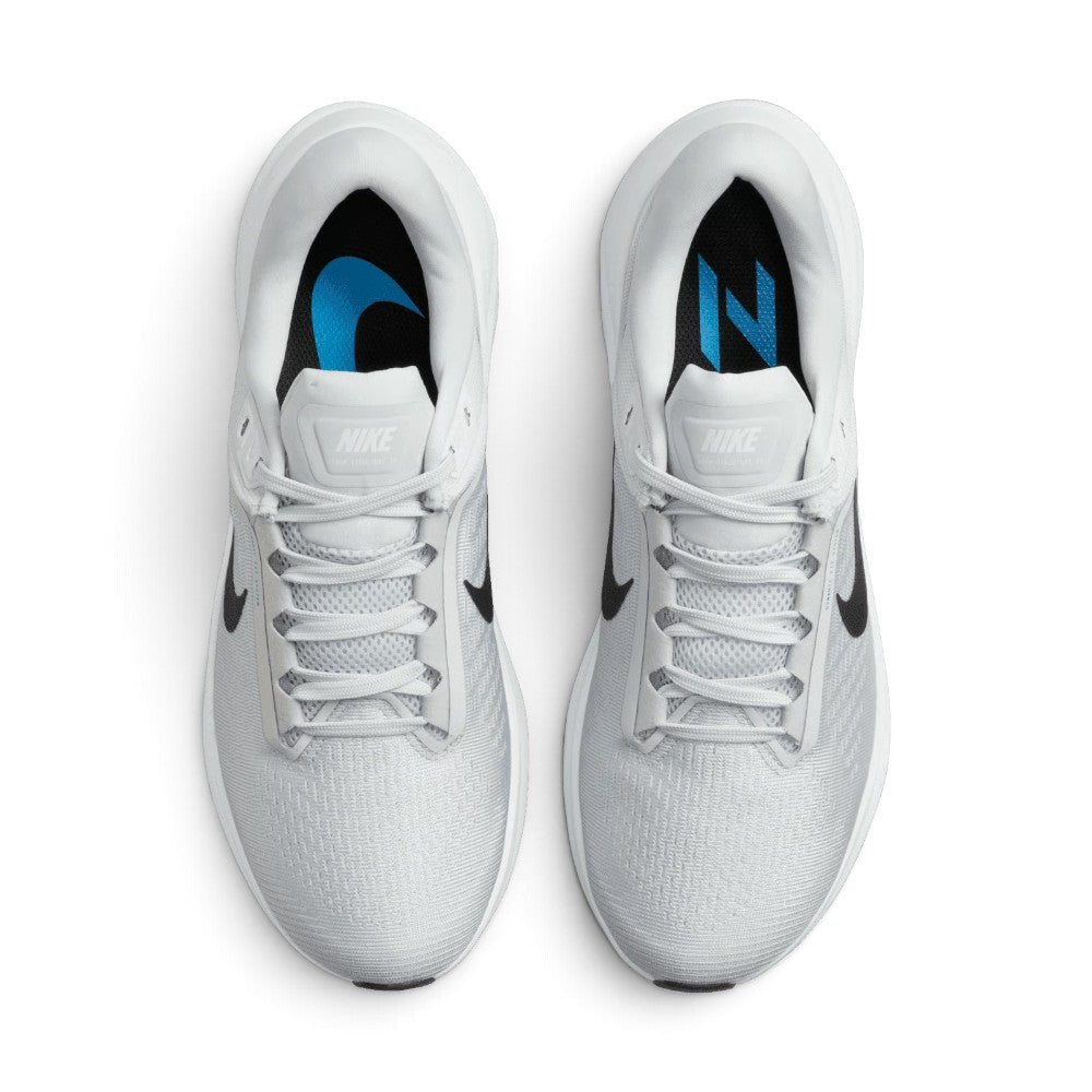 Focuses on the locked-in central lacing layout, displaying flat grey laces, padded mesh tongues with black Nike Air Zoom Structure 24 branding badges, and cushioned black insoles.