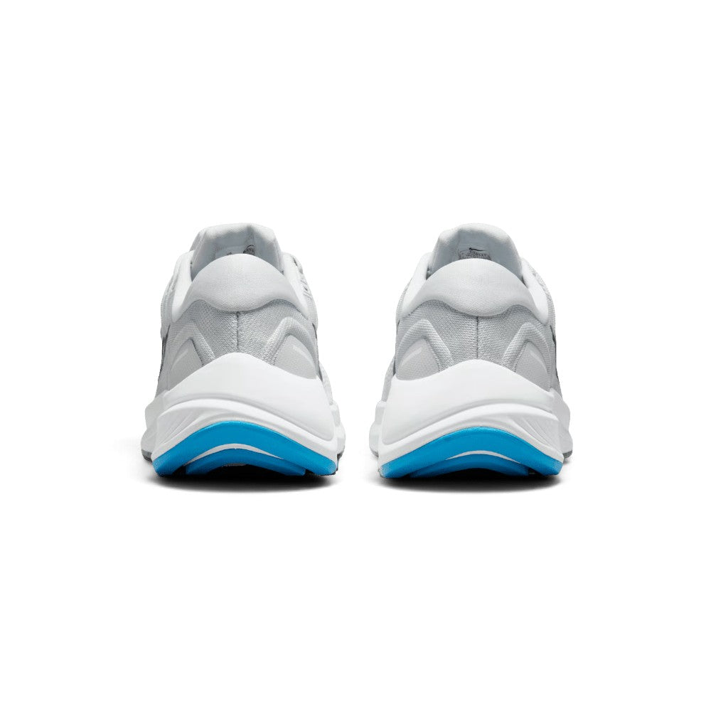 Focuses on the rear profile, displaying the structured grey moulded heel counter, reflective safety tab, and the wide flared footprint of the crash-pad midsole base.