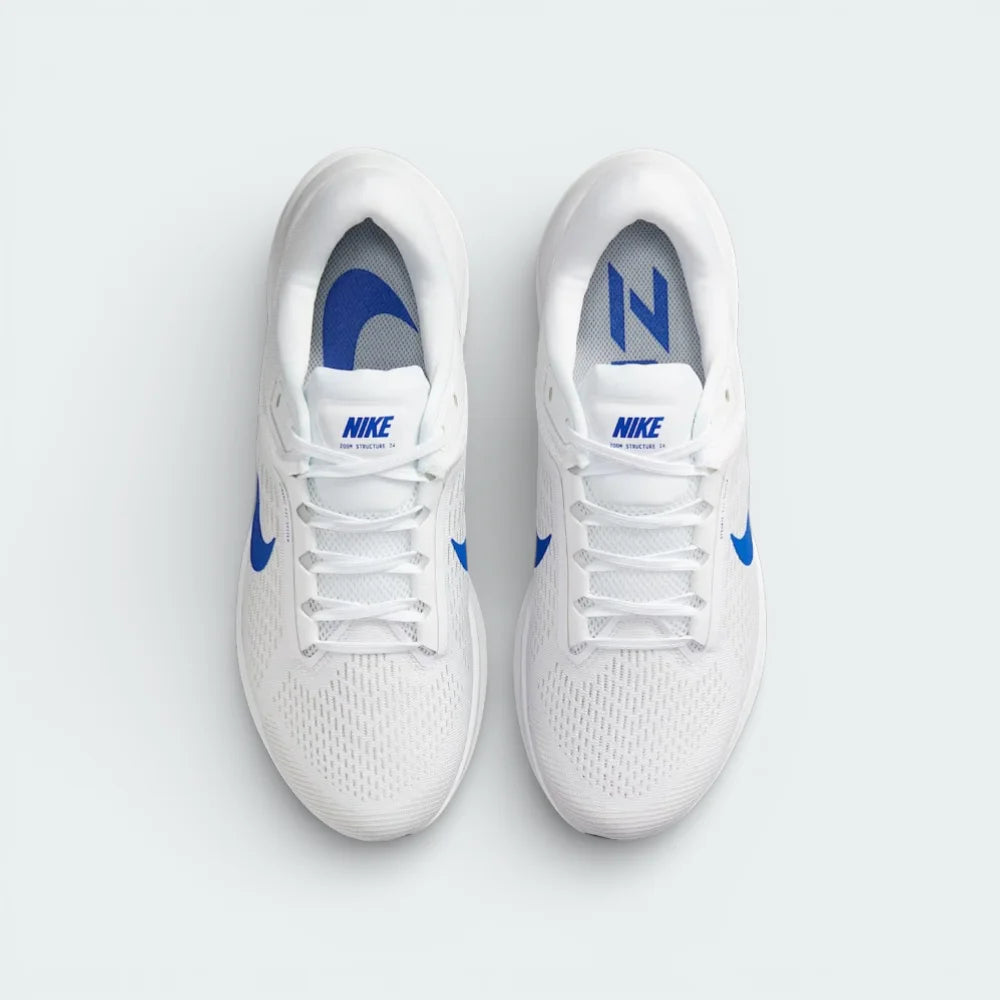 Top-down view of the white and blue Structure 24 trainers, highlighting the sleek lacing system and the breathable mesh texture across the toe box.