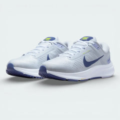 Angled shot of both Nike Air Zoom Structure 24 trainers side by side, showcasing the clean platinum aesthetic and soft blue accents.