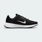 Black golf shoe with a white sole on a white background