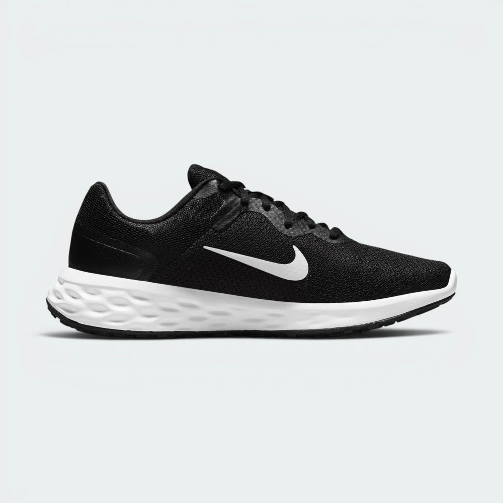 Black golf shoe with a white sole on a white background