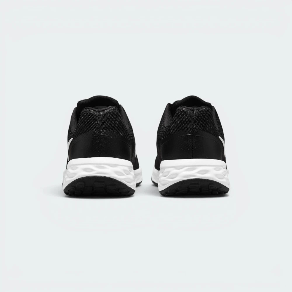 Focuses on the contoured shape of the padded low-cut collar, highlighting the smooth mesh heel panel and the wide, stable footprint of the cushioning foam sole unit below.