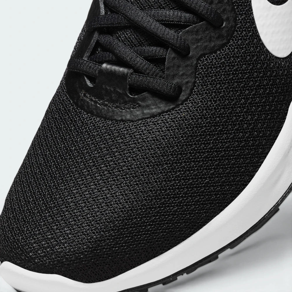 Details the premium precision of the seamless overlays wrapping the front toe cap to defend against debris, showing off the breathable perforations in the mesh up close.