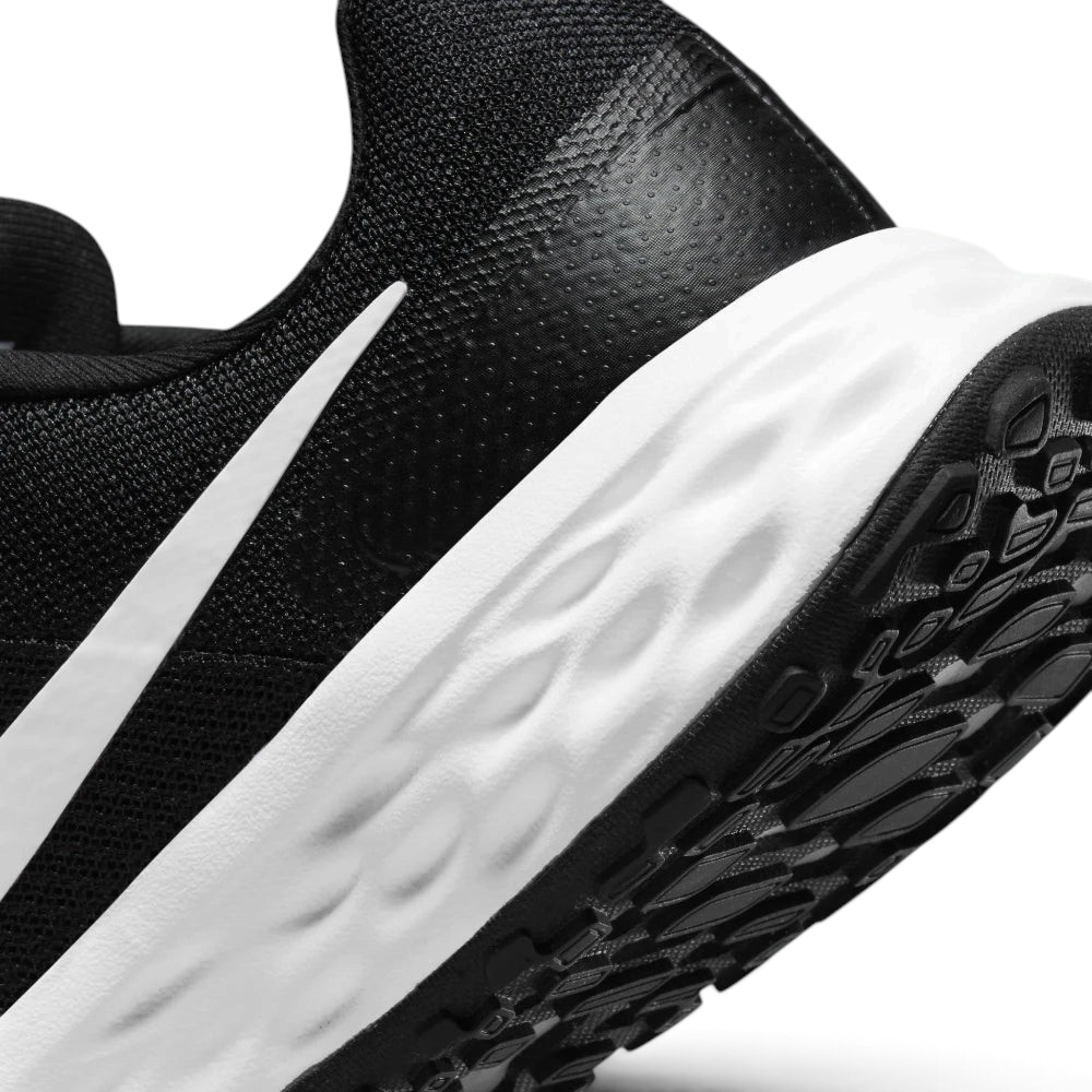 Highlights the "unreal" clean finish where the thick white foam cushioning carrier meets the durable dark traction rubber outsole, framing the micro-textured compression lines of the sole.