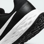 Highlights the "unreal" clean finish where the thick white foam cushioning carrier meets the durable dark traction rubber outsole, framing the micro-textured compression lines of the sole.