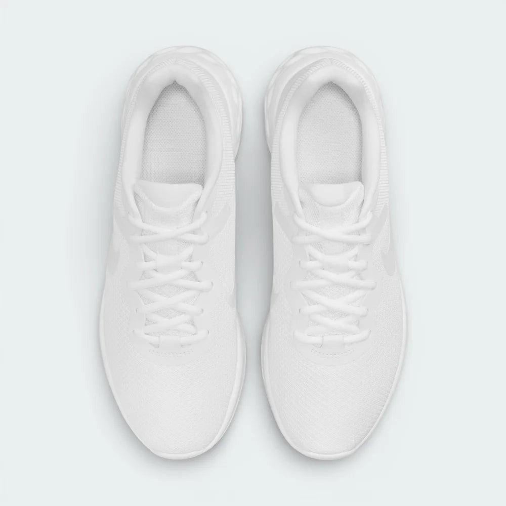 Top-down view of the Nike Revolution 6 white trainers, highlighting the minimalist lacing system and breathable mesh texture on the toe box.