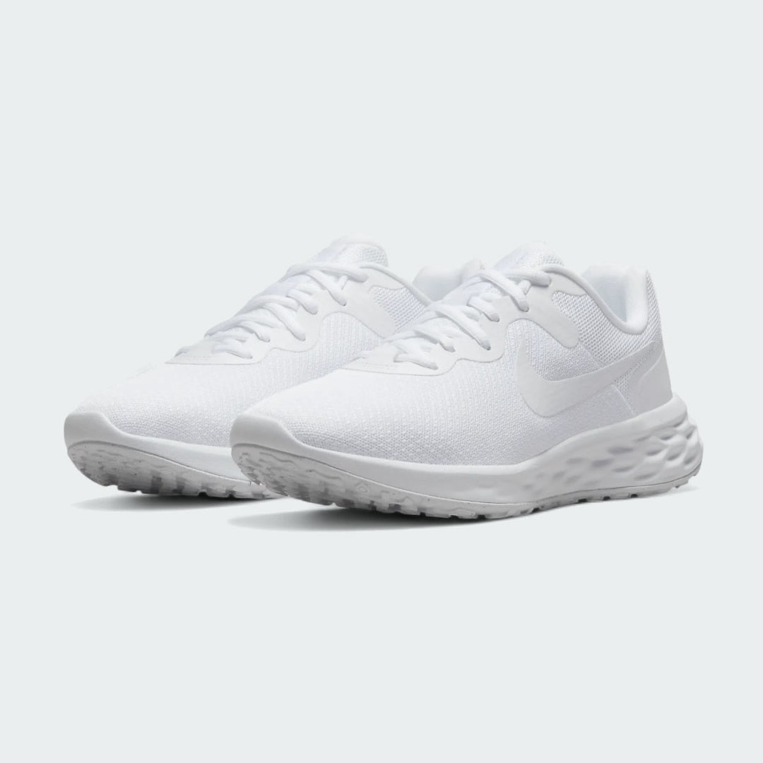 Angled view of two Nike Revolution 6 Women's white training shoes, side by side, showcasing their versatile design and cushioned profile.