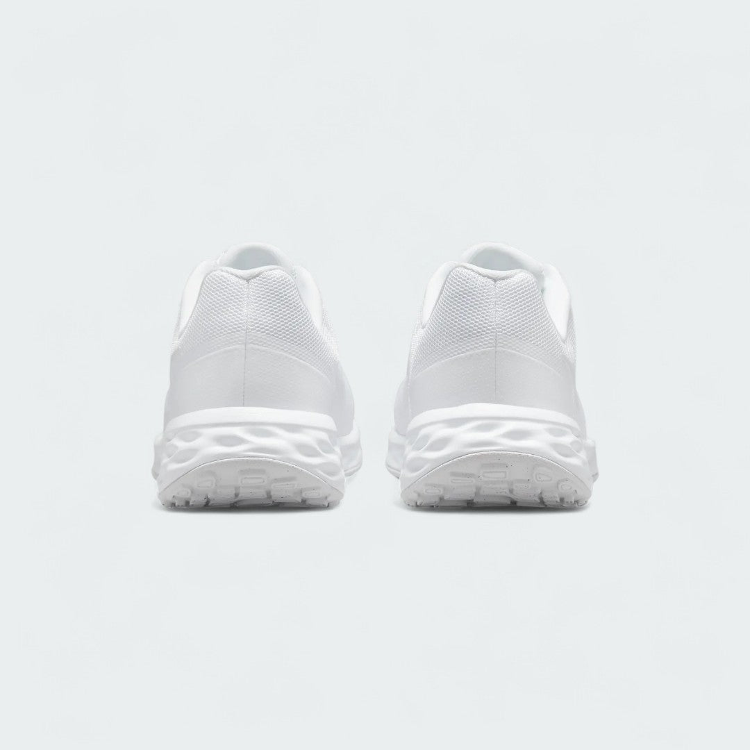 Rear view of the Nike Revolution 6 Women's white training shoes, focusing on the structured heel and subtle branding.