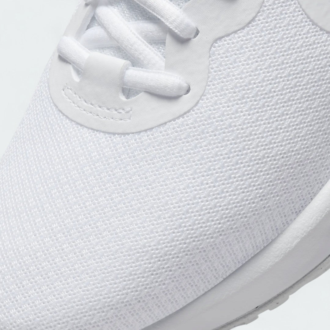 Close-up zoom on the front of the Nike Revolution 6 Women's white training shoes, showing the mesh upper texture, lacing system, and seamless overlays.