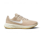 Side profile of the Nike Revolution 6 in Sand Drift, showing the white Swoosh, Topaz Gold accents, and the clean white foam midsole.