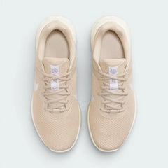 Top-down view of the women's Revolution 6 trainers, highlighting the light brown mesh texture and the secure Sand Drift lacing system.
