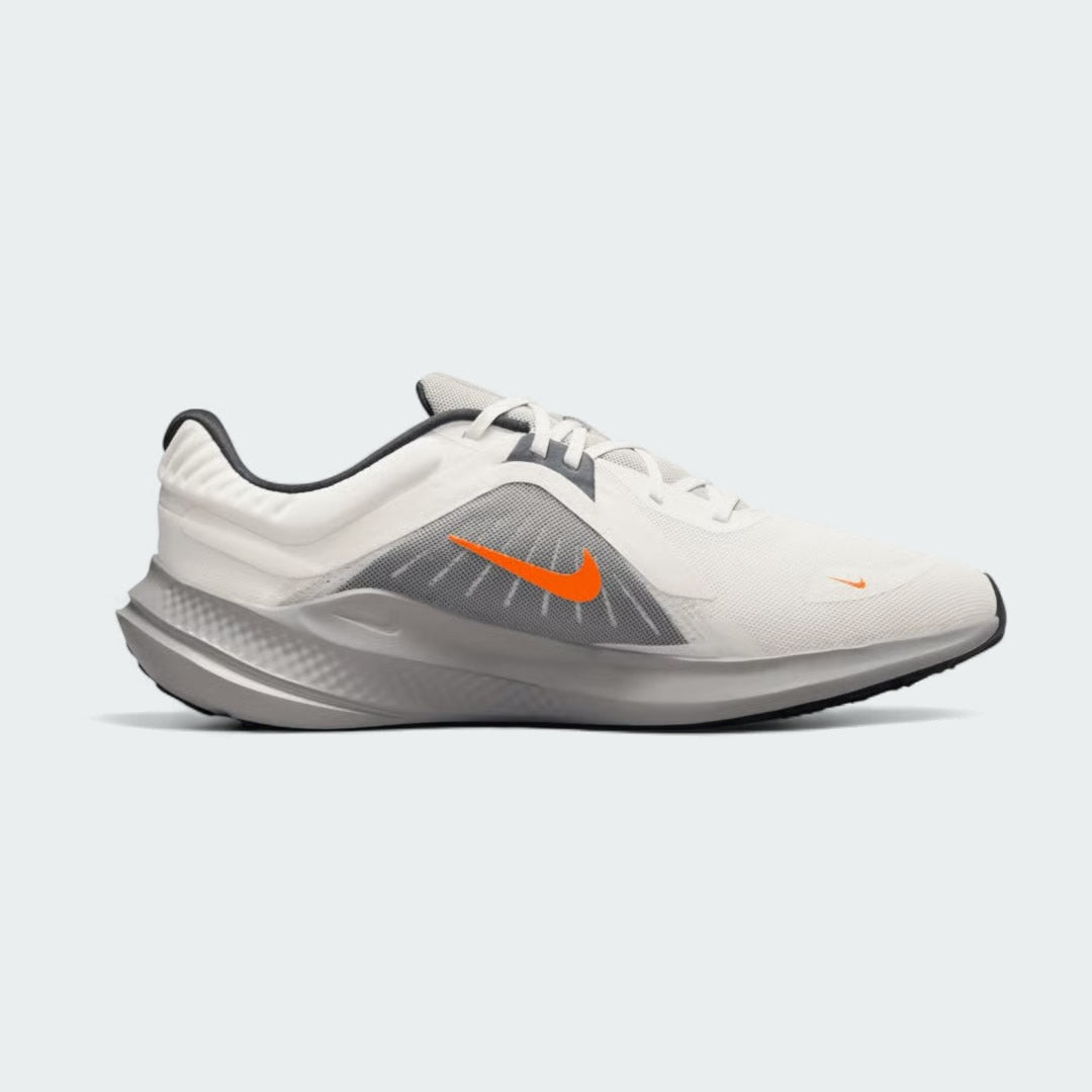 Nike Quest 5 Men's running shoe in sail (off-white) with thunder blue and total orange accents, side profile showing breathable mesh upper and contoured sole.