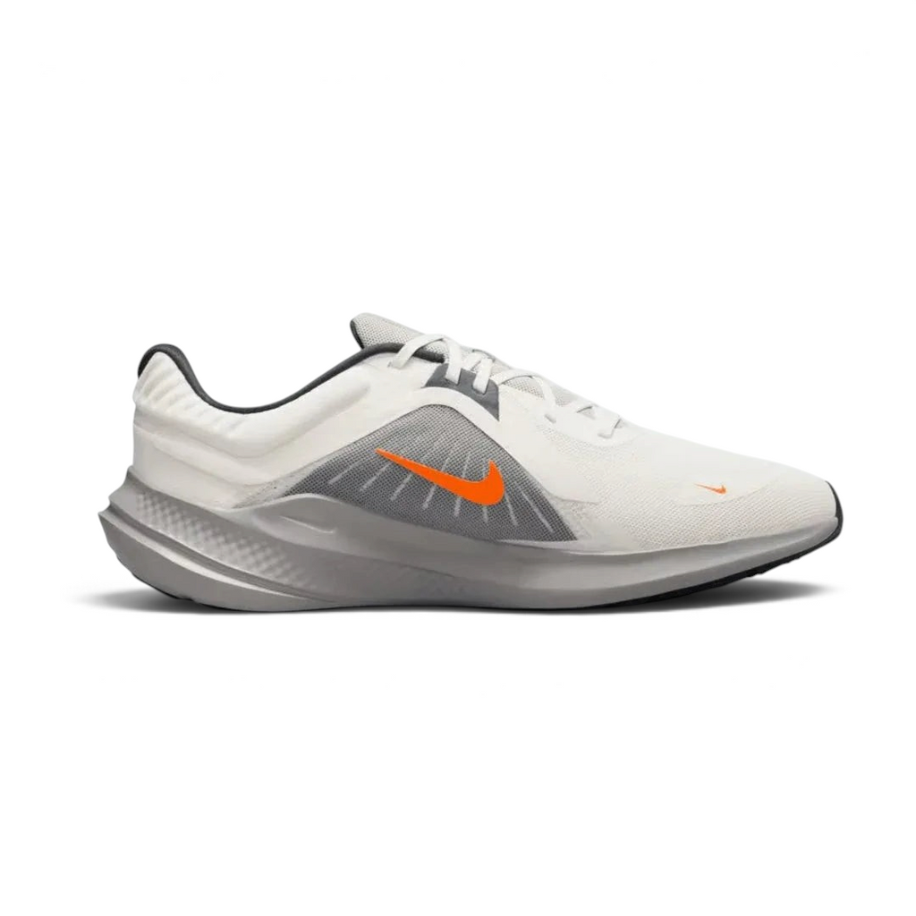 Nike Quest 5 Men's running shoe in sail (off-white) with thunder blue and total orange accents, side profile showing breathable mesh upper and contoured sole.