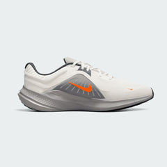 Nike Quest 5 Men's running shoe in sail (off-white) with thunder blue and total orange accents, side profile showing breathable mesh upper and contoured sole.