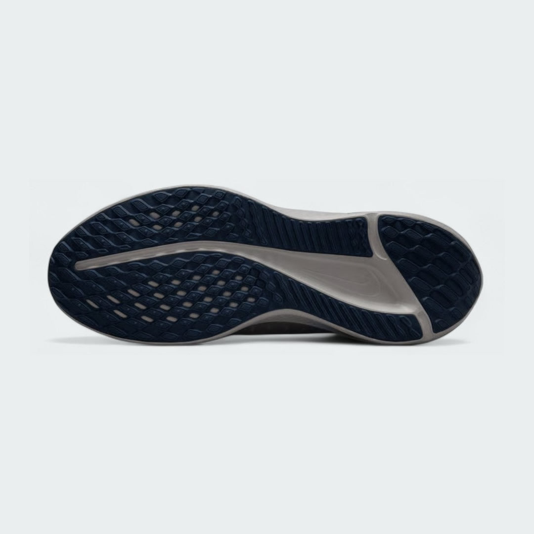 View of the outsole of the Nike Quest 5 Men's running shoes, showing the durable rubber tread pattern for road traction.
