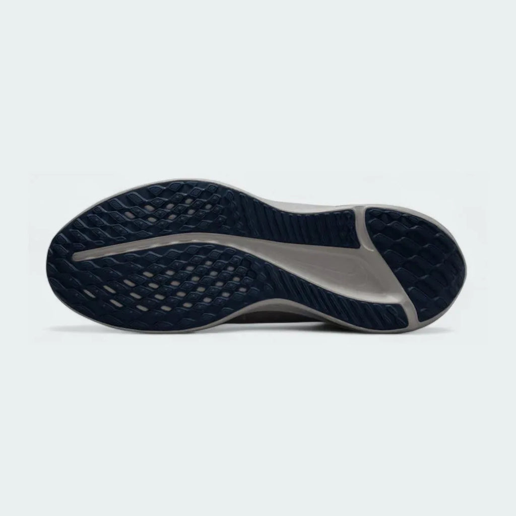View of the outsole of the Nike Quest 5 Men's running shoes, showing the durable rubber tread pattern for road traction.