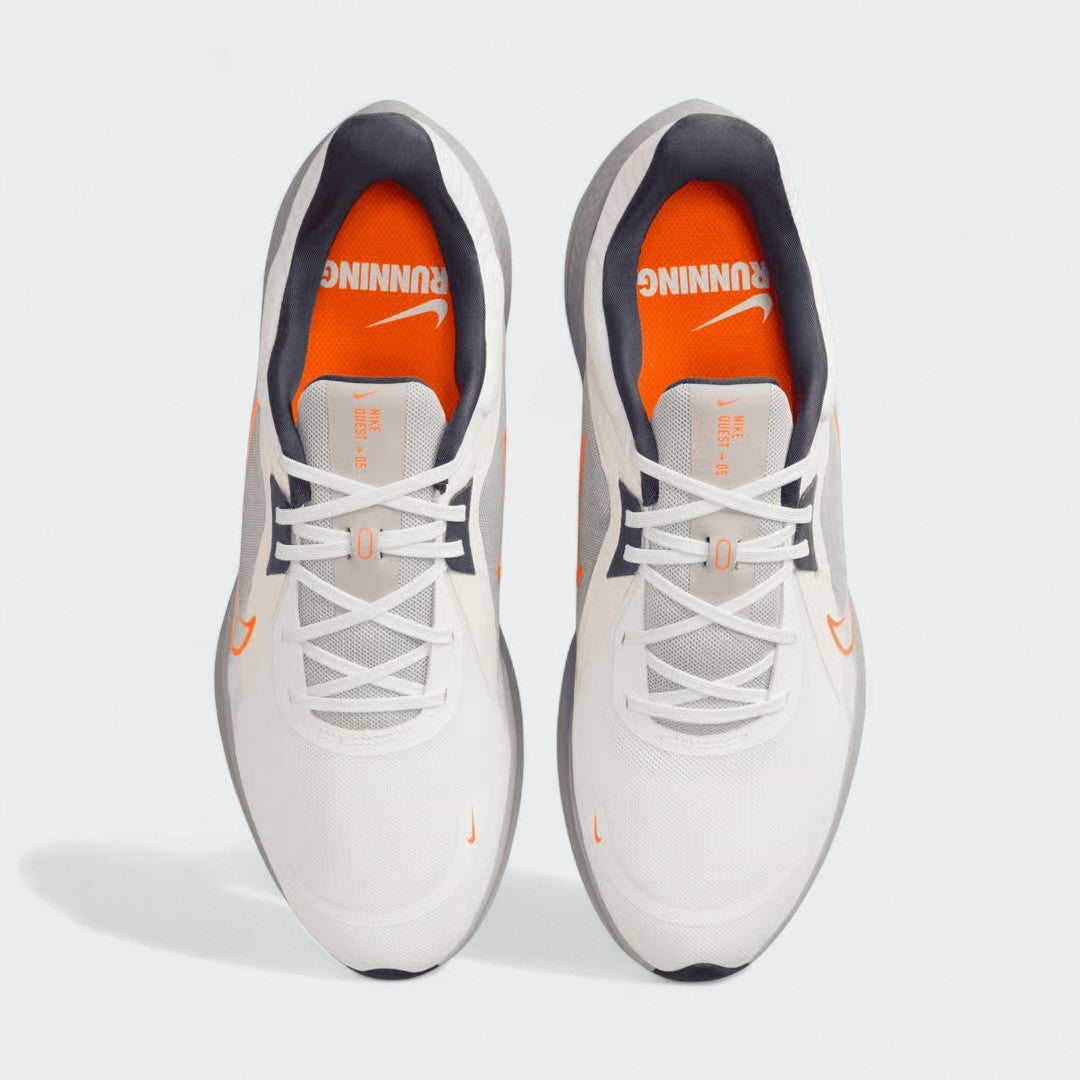 Top-down view of a pair of Nike Quest 5 Men's running shoes in sail, highlighting their breathable mesh construction and lacing system.