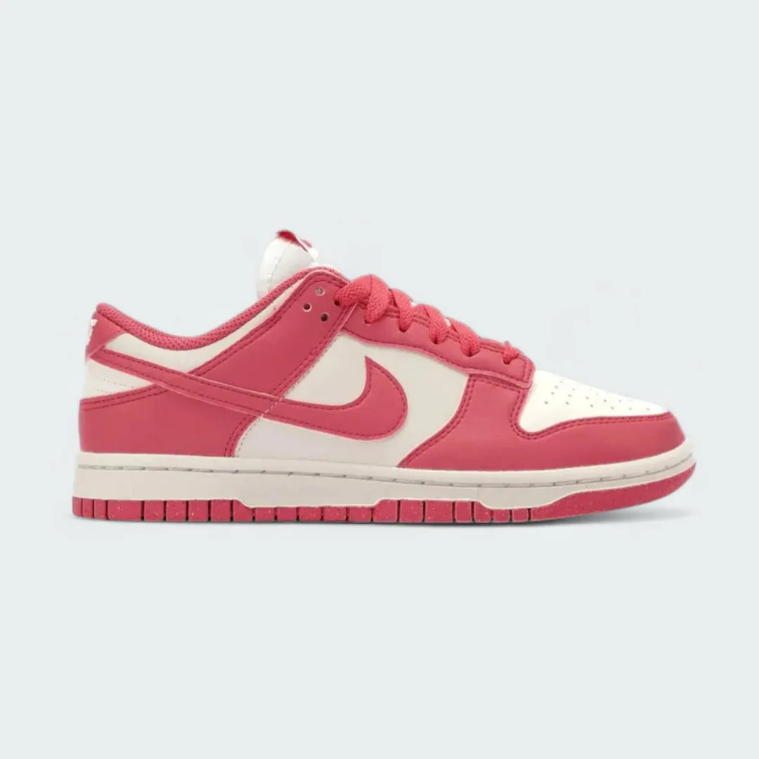 Nike Dunk Low Next Nature Women's trainers in pink leather with a white Swoosh, side profile showing classic leather upper and white midsole. Main image