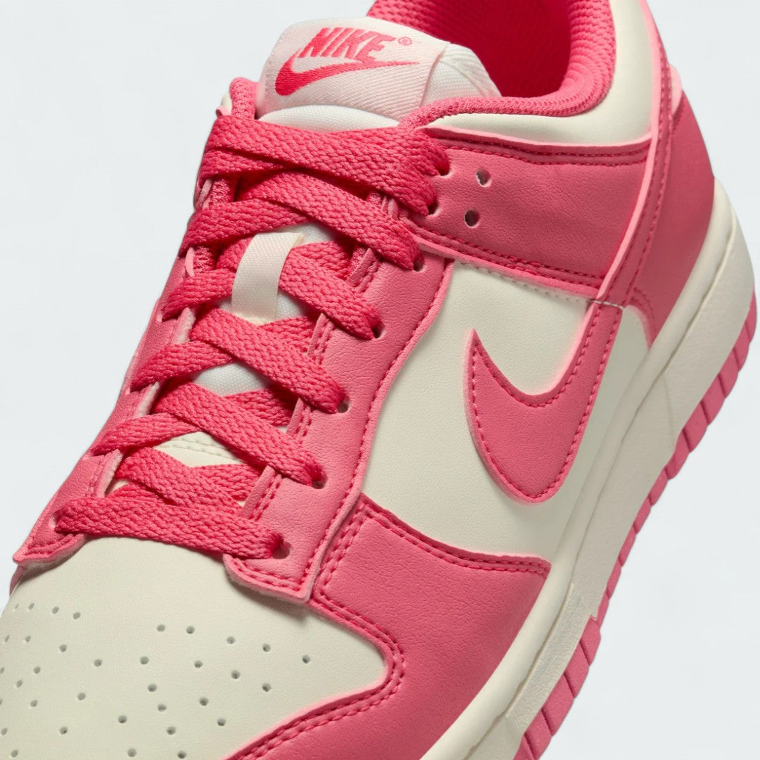 Close-up zoom on the front of the Nike Dunk Low Next Nature Women's pink trainers, showing the perforated toe box, lacing system, and texture of the upper materials.