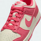 Close-up zoom on the front of the Nike Dunk Low Next Nature Women's pink trainers, showing the perforated toe box, lacing system, and texture of the upper materials.