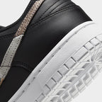 Detailed zoom on the outsole and midsole of the Nike Dunk Low SE Women's black leather trainers, highlighting the cushioned foam and durable rubber outsole.