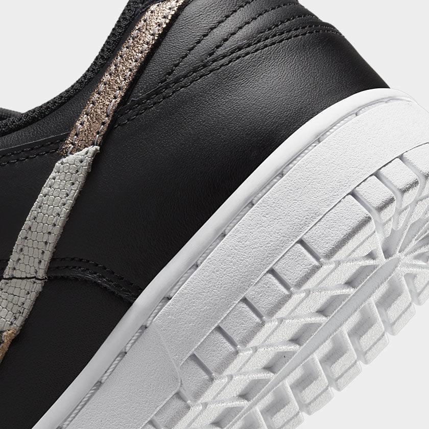 Detailed zoom on the outsole and midsole of the Nike Dunk Low SE Women's black leather trainers, highlighting the cushioned foam and durable rubber outsole.