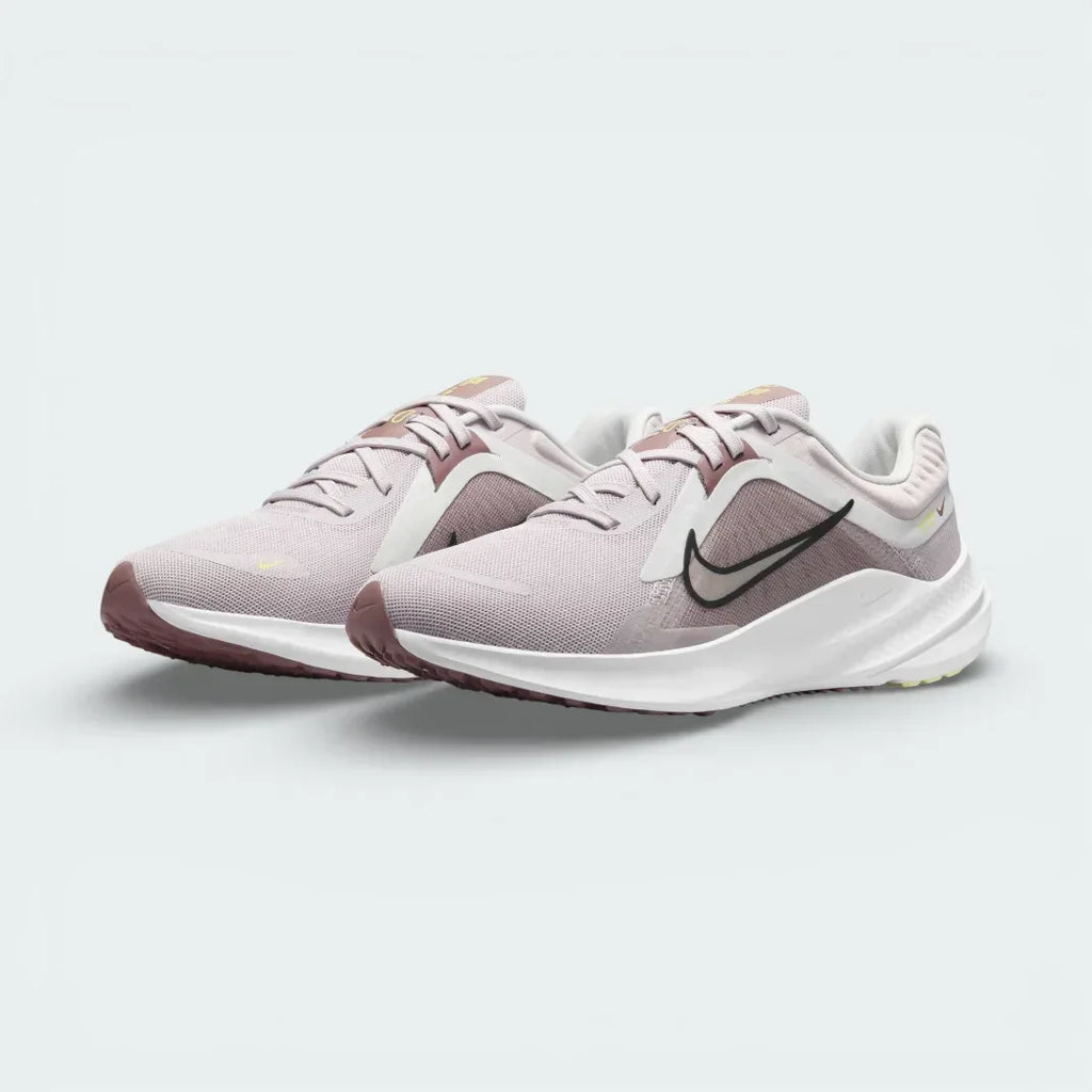 Angled view of two Nike Quest 5 Women's shoes side by side, showcasing the sleek violet design and modern running silhouette.
