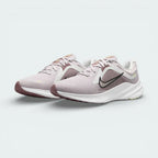 Angled view of two Nike Quest 5 Women's shoes side by side, showcasing the sleek violet design and modern running silhouette.