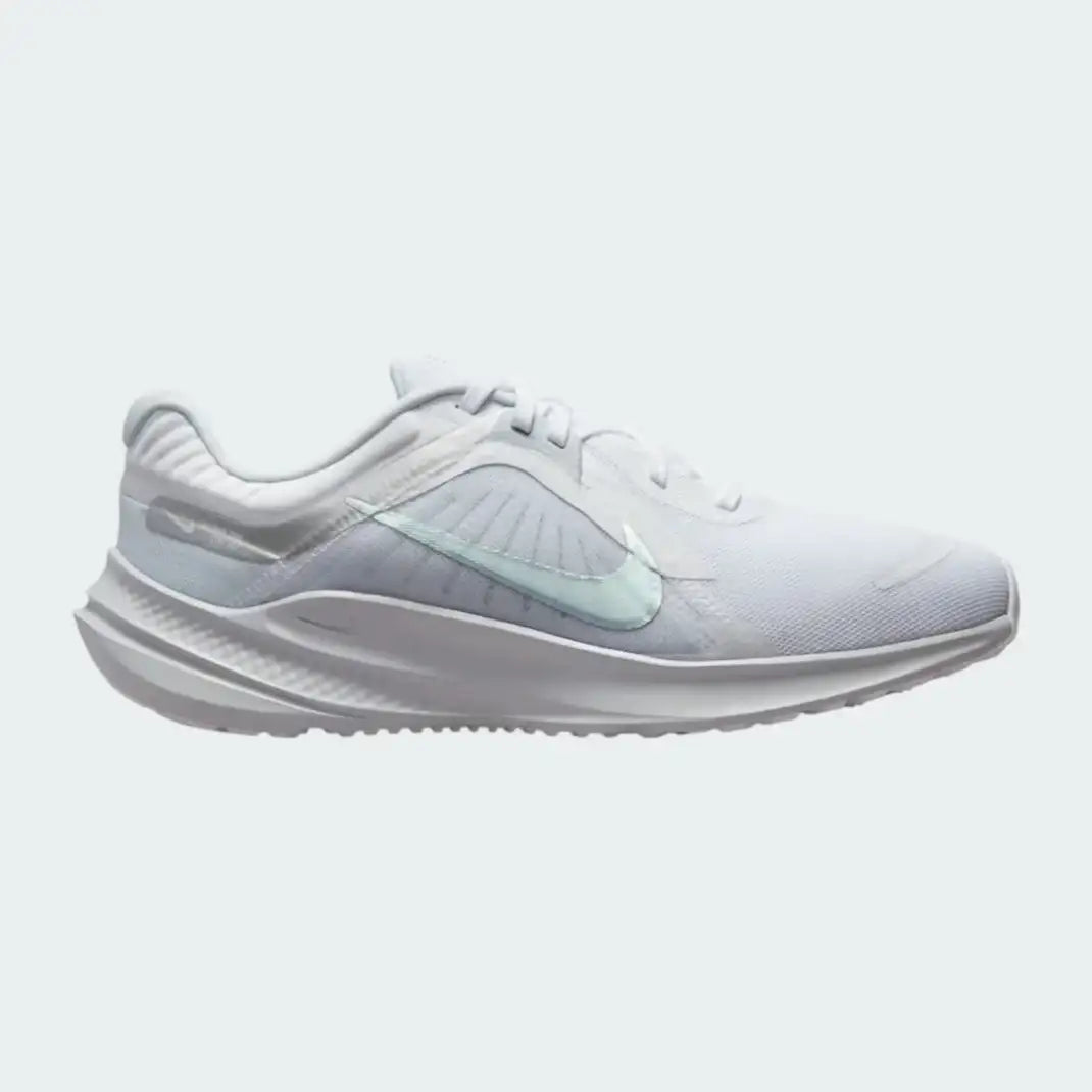 Nike Quest 5 Women's running shoe in white with metallic silver accents, side profile showing breathable mesh upper, foam cushioning, and Nike Swoosh.