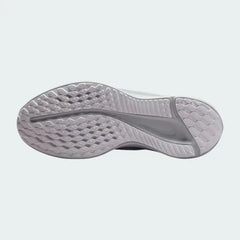 View of the outsole of the Nike Quest 5 Women's white running shoes, showing the durable rubber tread pattern for road traction.