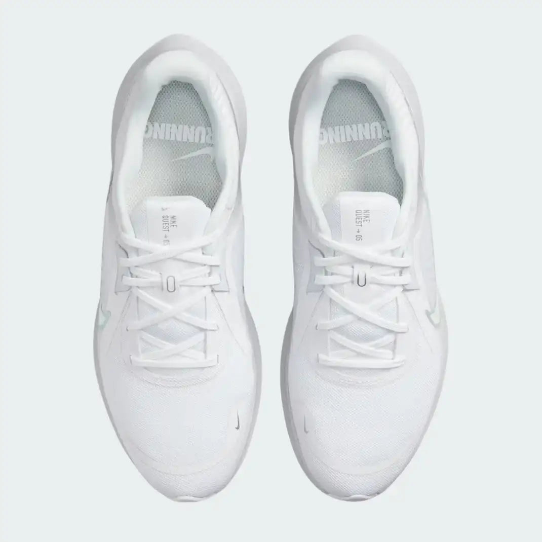 Top-down view of a pair of Nike Quest 5 Women's running shoes in white, highlighting their streamlined silhouette and lace-up closure.