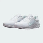 Angled view of two Nike Quest 5 Women's white running shoes, side by side, showcasing their versatile design and cushioned profile.