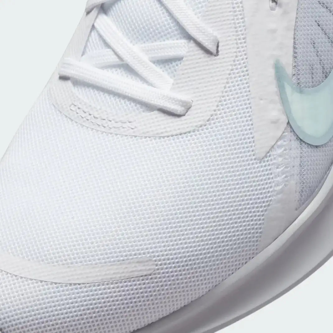 Close-up zoom on the front of the Nike Quest 5 Women's white running shoes, showing the mesh upper texture and integrated lacing system.