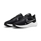 Angled view of two Nike Downshifter 12 Men's black and white training shoes, side by side, showcasing their versatile design and cushioned profile.