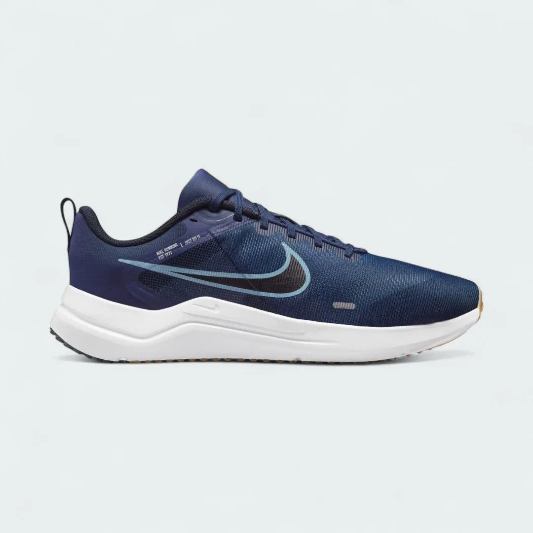 Nike Downshifter 12 Men's training shoes in navy blue with white accents, side profile showing mesh upper, foam cushioning, and Nike Swoosh. Main image