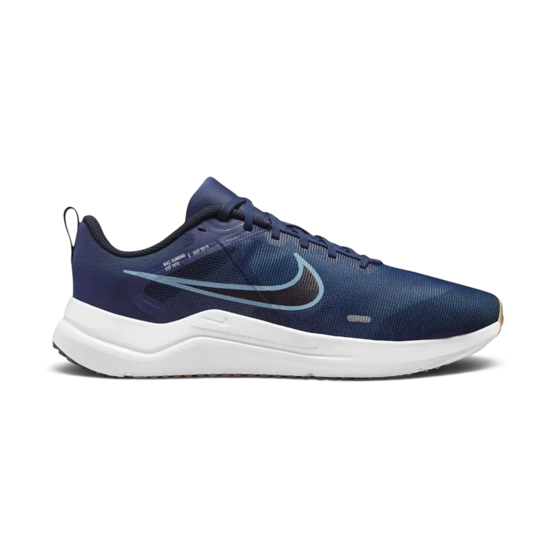 Nike Downshifter 12 Men's training shoes in navy blue with white accents, side profile showing mesh upper, foam cushioning, and Nike Swoosh.