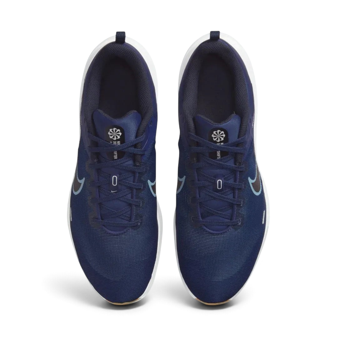 Top-down view of a pair of Nike Downshifter 12 Men's training shoes in navy blue, highlighting their streamlined silhouette and lace-up closure.