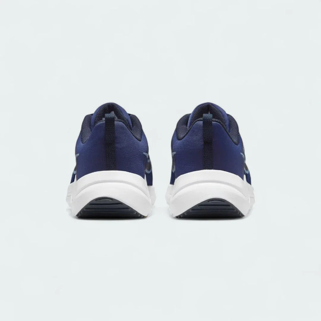 Rear view of the Nike Downshifter 12 Men's navy blue training shoes, focusing on the structured heel and subtle branding.