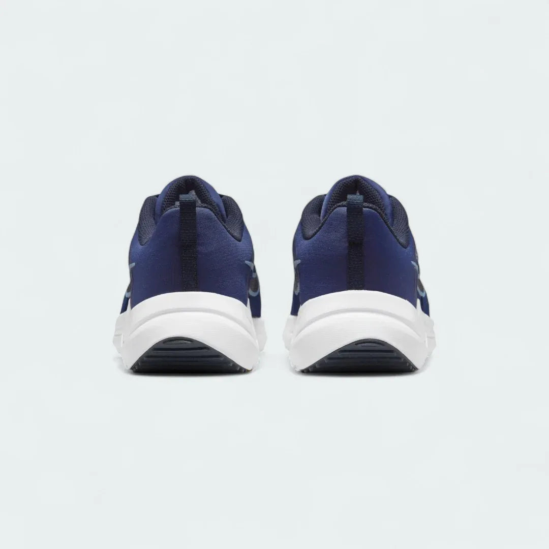 Rear view of the Nike Downshifter 12 Men's navy blue training shoes, focusing on the structured heel and subtle branding.