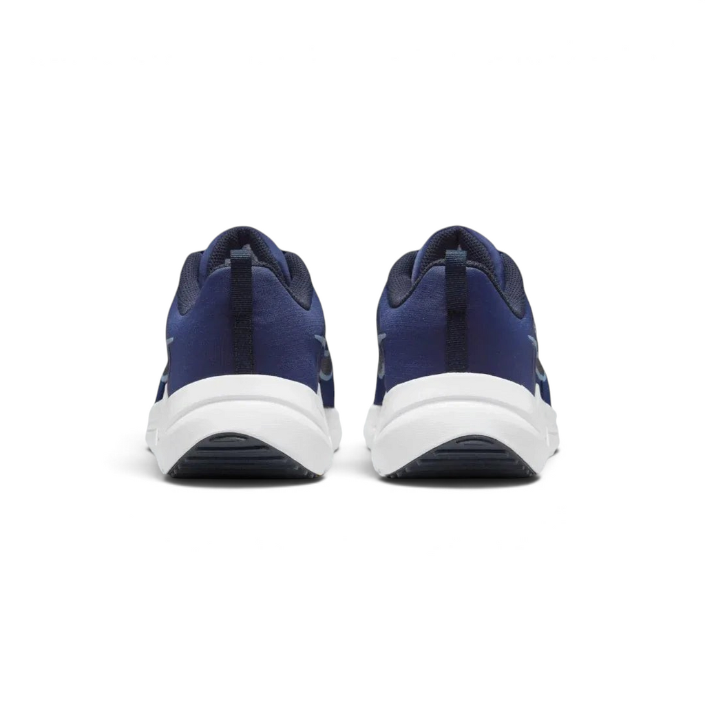 Rear view of the Nike Downshifter 12 Men's navy blue training shoes, focusing on the structured heel and subtle branding.