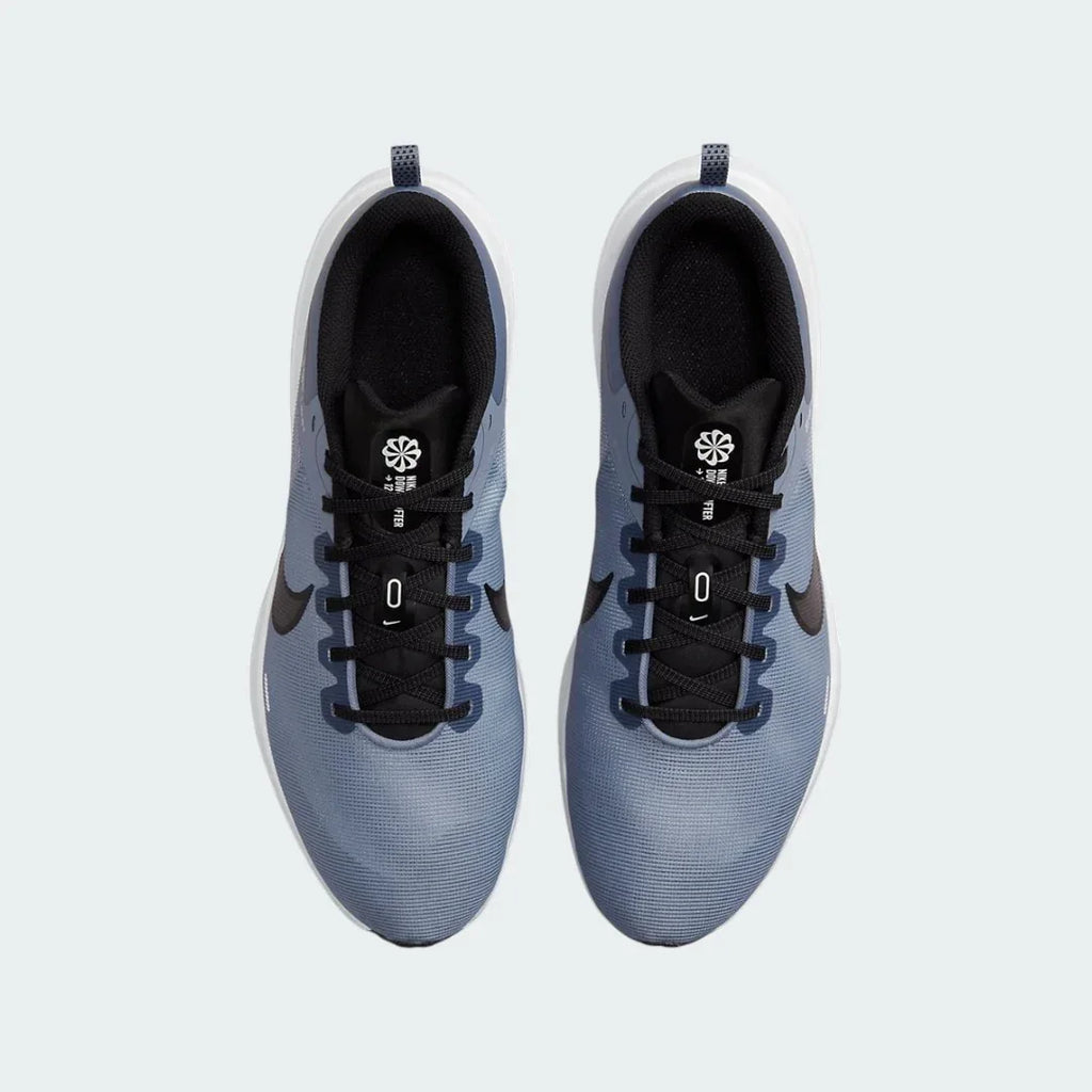 Top-down view of a pair of Nike Downshifter 12 Men's training shoes in grey, highlighting their streamlined silhouette and lace-up closure.
