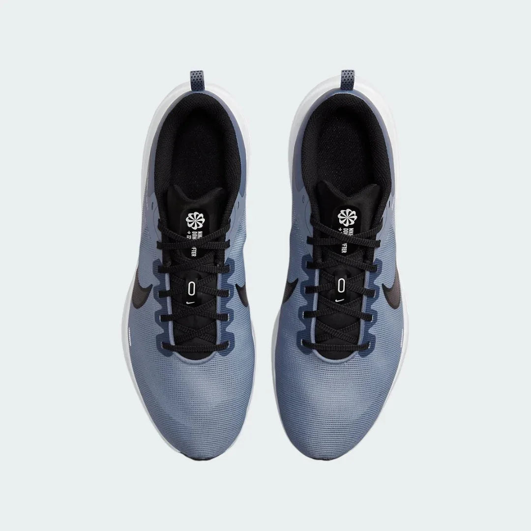 Top-down view of a pair of Nike Downshifter 12 Men's training shoes in grey, highlighting their streamlined silhouette and lace-up closure.